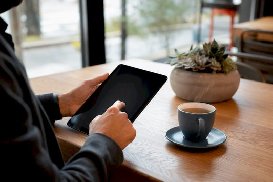 Hands holding tablet with CBT ebook blurred screen